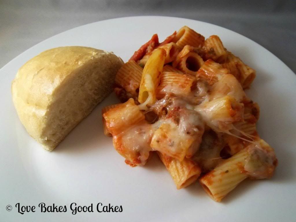Meaty Pasta Bake with garlic toast on white plate.