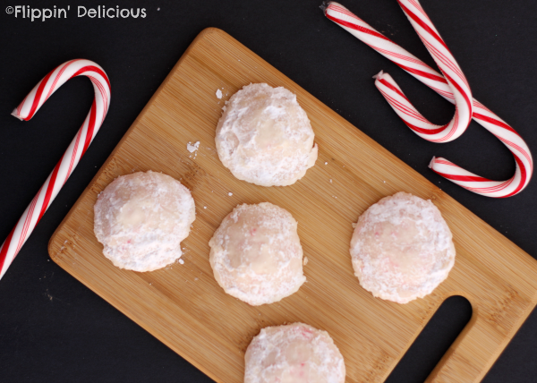 Gluten-Free Peppermint Snowball Cookies are buttery, crisp peppermint cookies with crushed candy canes inside all rolled in sweet powdered sugar. Perfect for the Holidays!